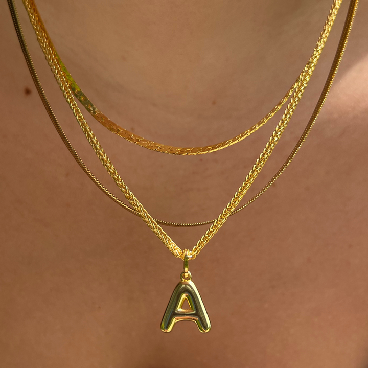 Layering necklace in gold and silver tones displayed on a clean background