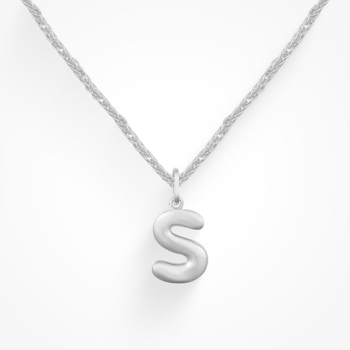Layering necklace in gold and silver tones displayed on a clean background