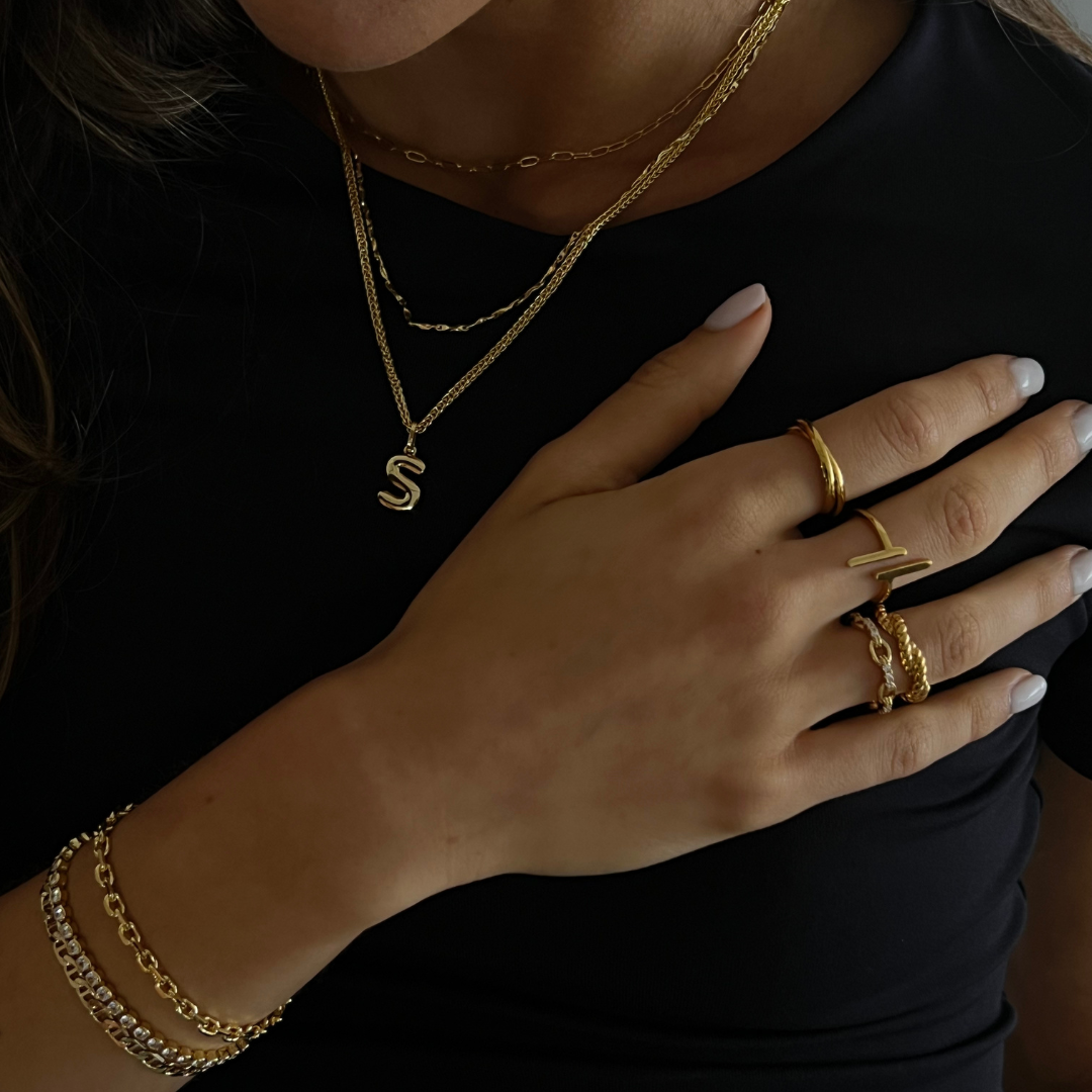 Layering necklace in gold and silver tones displayed on a clean background