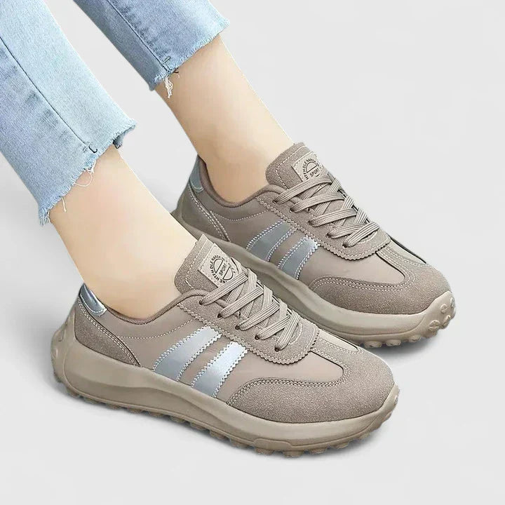 A woman wearing grey orthopaedic trainers on a city stroll