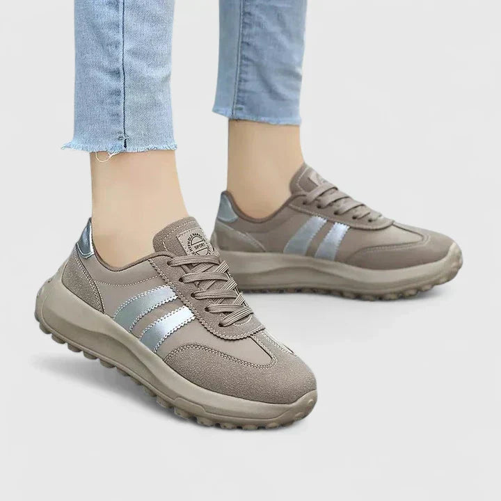 A woman wearing grey orthopaedic trainers on a city stroll