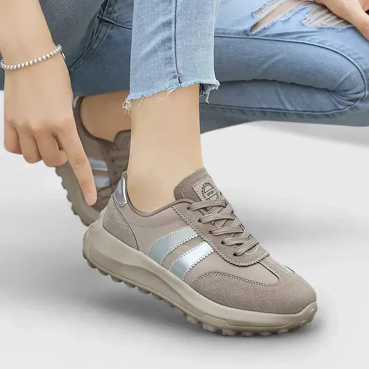 A woman wearing grey orthopaedic trainers on a city stroll