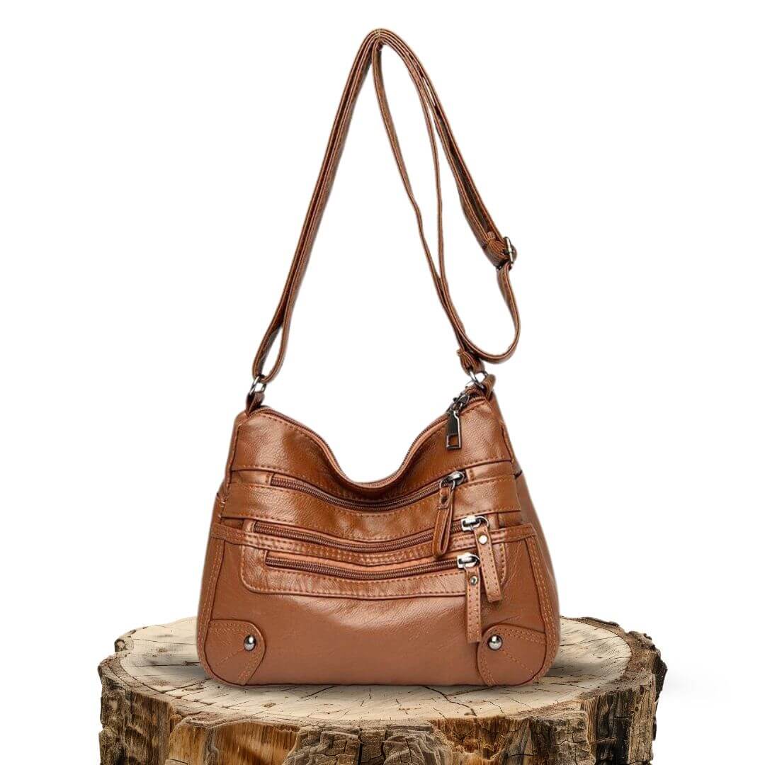 A woman carrying an elegant roomy tote bag on her shoulder while out shopping.