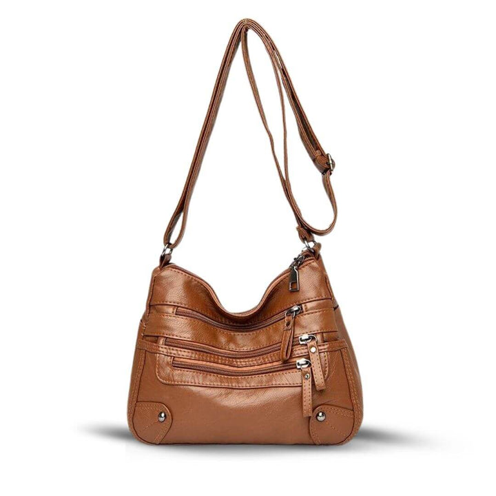 A woman carrying an elegant roomy tote bag on her shoulder while out shopping.