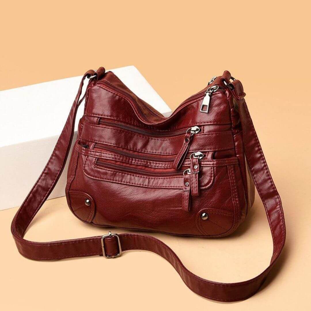 A woman carrying an elegant roomy tote bag on her shoulder while out shopping.