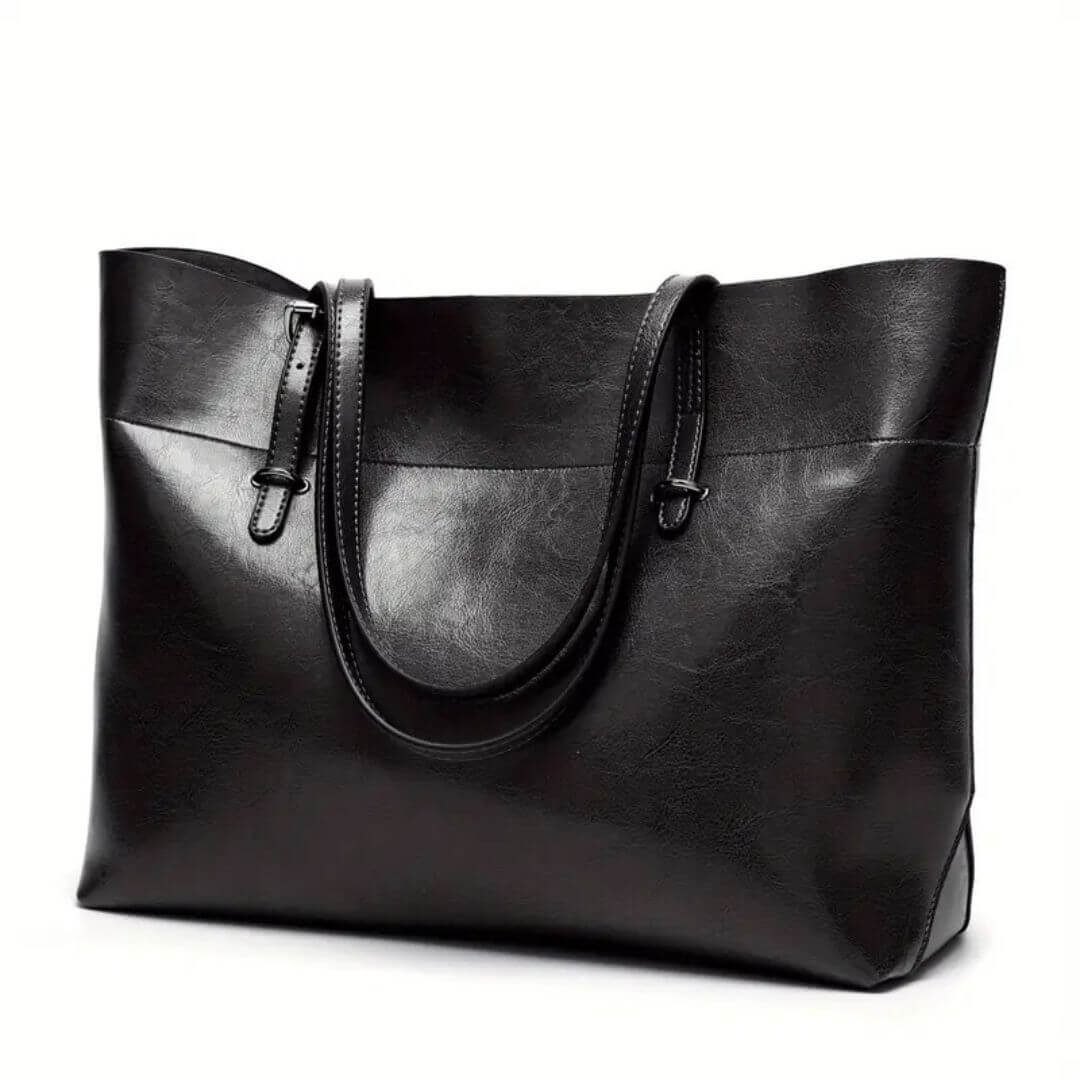 A woman carrying an elegant everyday handbag on her arm while out in town.