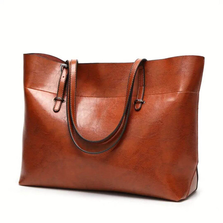 A woman carrying an elegant everyday handbag on her arm while out in town.