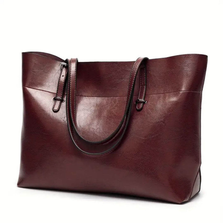 A woman carrying an elegant everyday handbag on her arm while out in town.