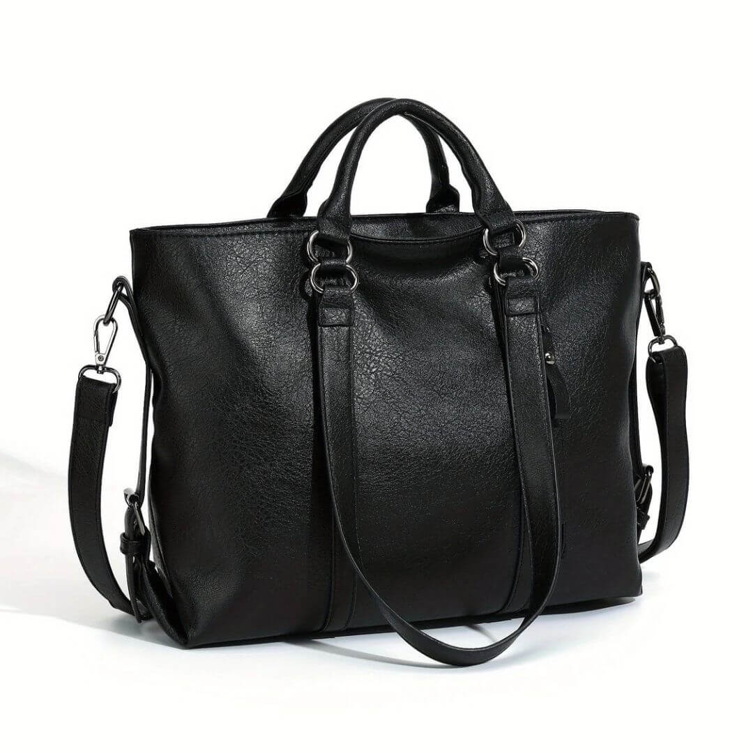 A woman carrying a soft pouch-style bag on her shoulder while out for coffee in town.