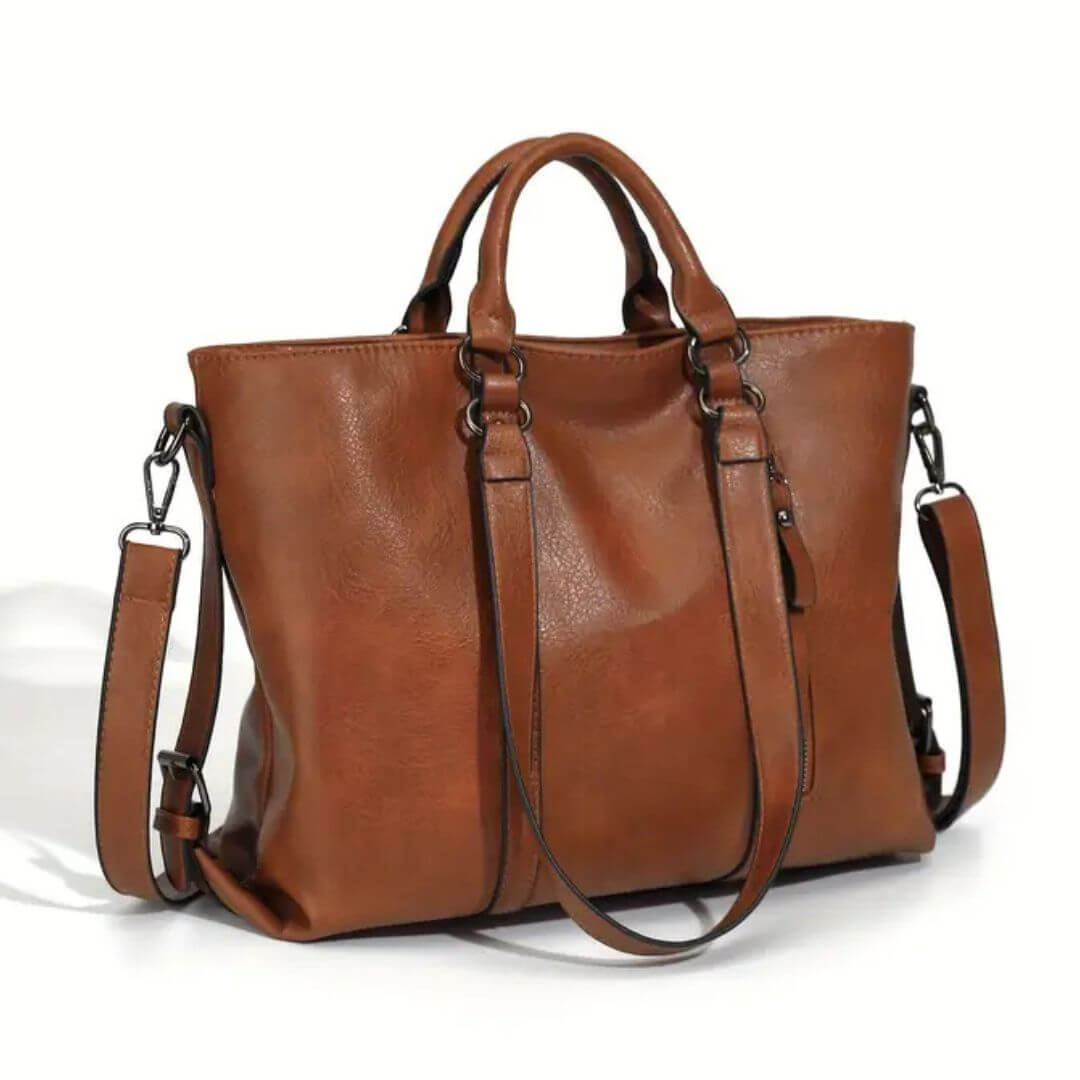 A woman carrying a roomy everyday tote bag on her shoulder while out for coffee in town.