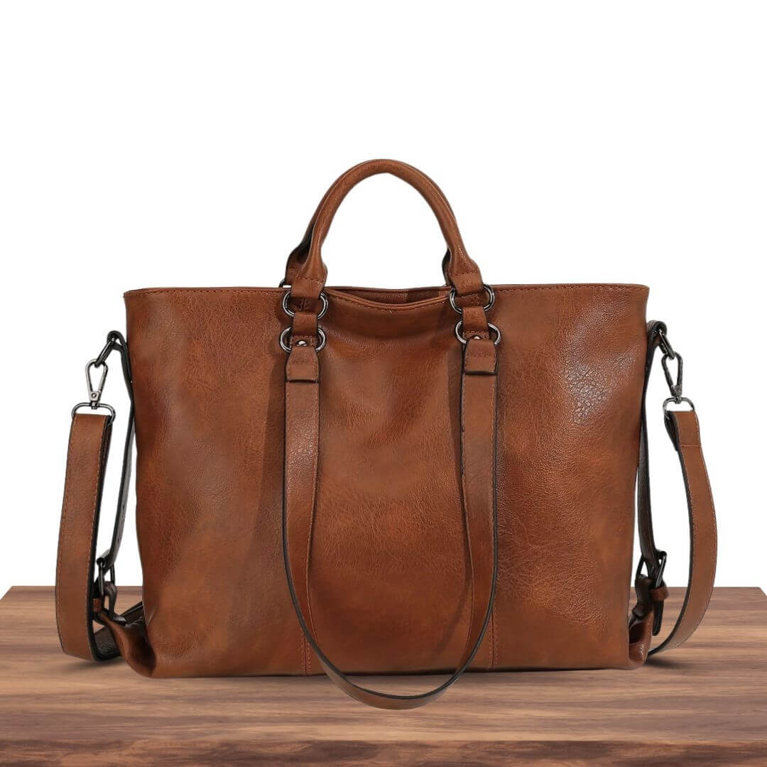A woman carrying a soft pouch-style bag on her shoulder while out for coffee in town.