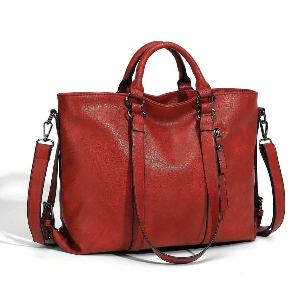 A woman carrying a soft pouch-style bag on her shoulder while out for coffee in town.