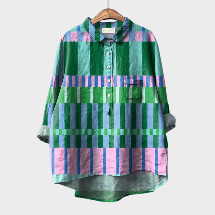 Woman wearing a colourful multicolour checked summer blouse with a soft, airy drape.