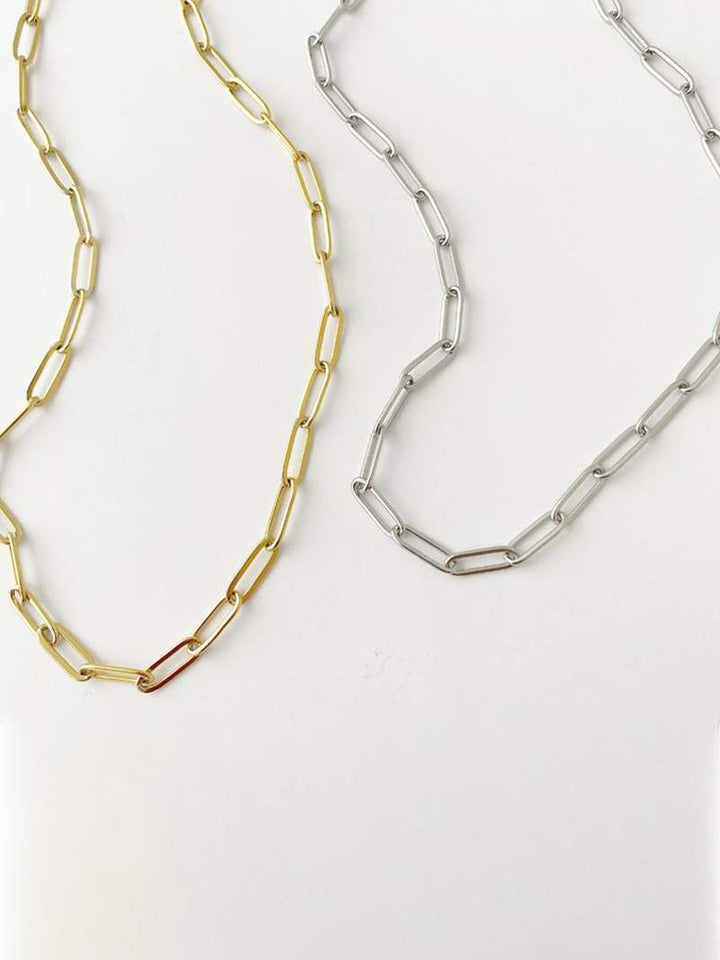 Gold-plated bicycle charm pendant necklace on a white background