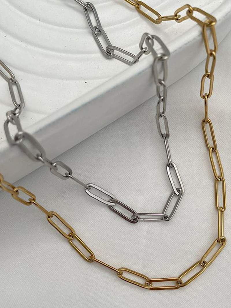 Gold-plated bicycle charm pendant necklace on a white background