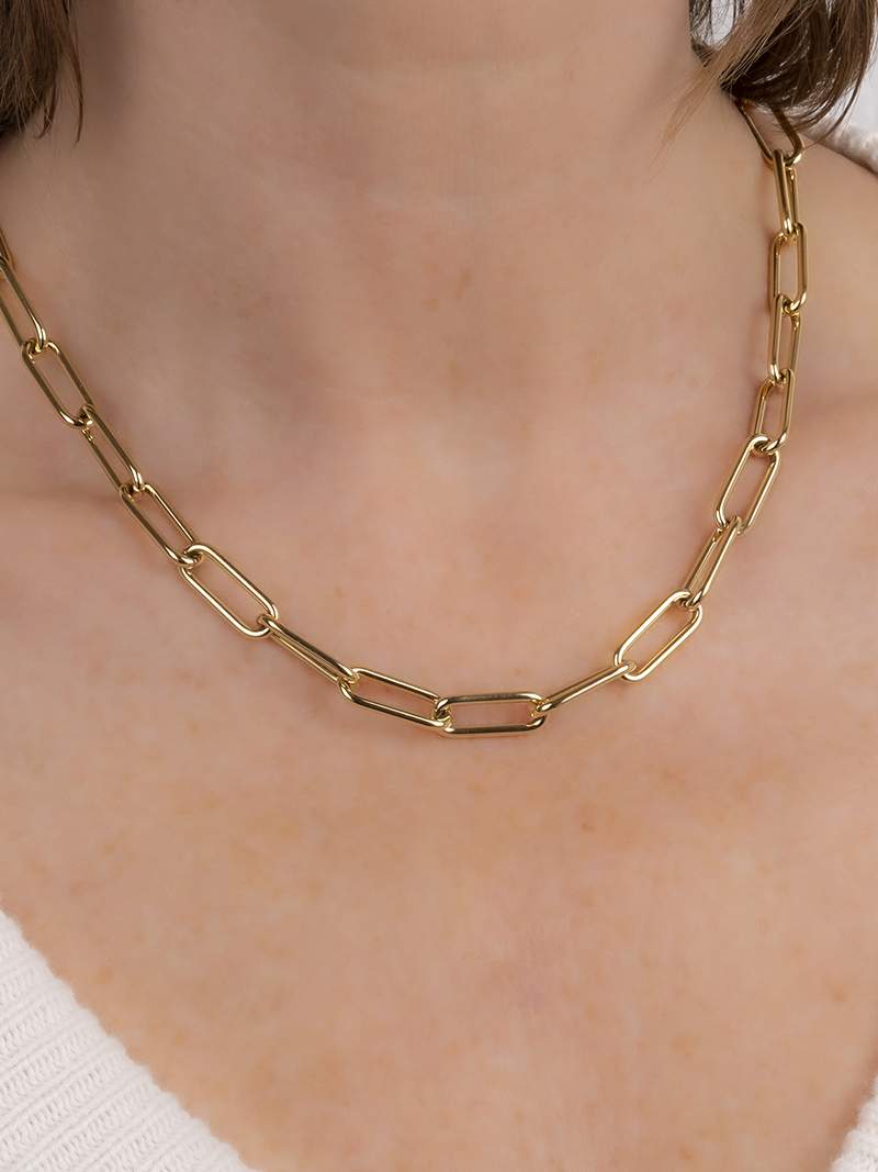 Gold-plated bicycle charm pendant necklace on a white background