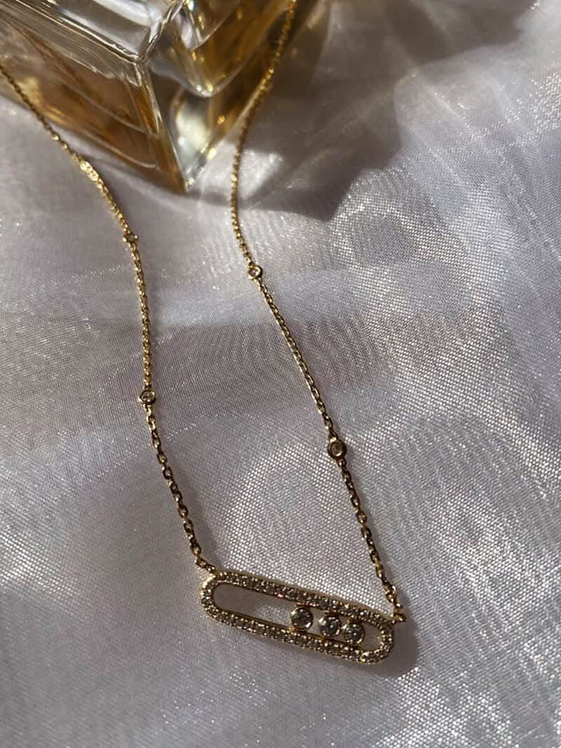 Delicate pendant necklace with three dancing diamond stones in yellow gold finish