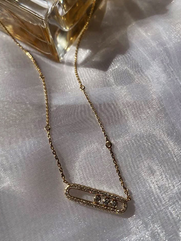 Delicate pendant necklace with three dancing diamond stones in yellow gold finish