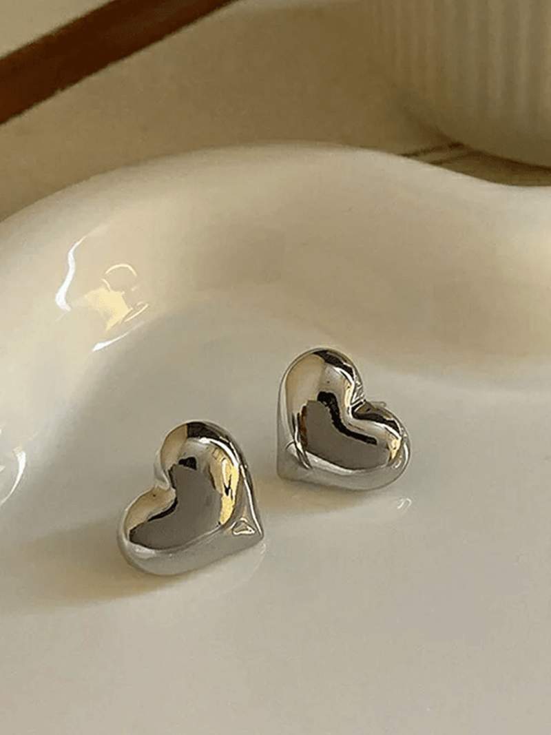 Delicate gold heart-shaped stud earrings