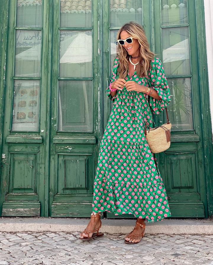 A woman wearing the Concepta spring print dress in green and pink tones, styled for a day out.