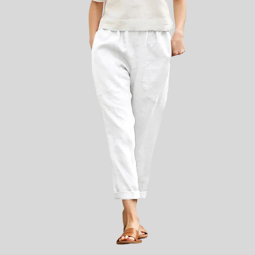 A woman wearing wide relaxed trousers with two roomy pockets and an elastic waist.