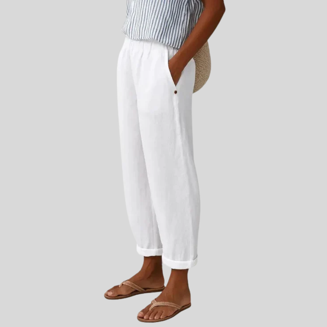 A woman wearing chic comfy trousers with a modern relaxed cut and flattering silhouette.
