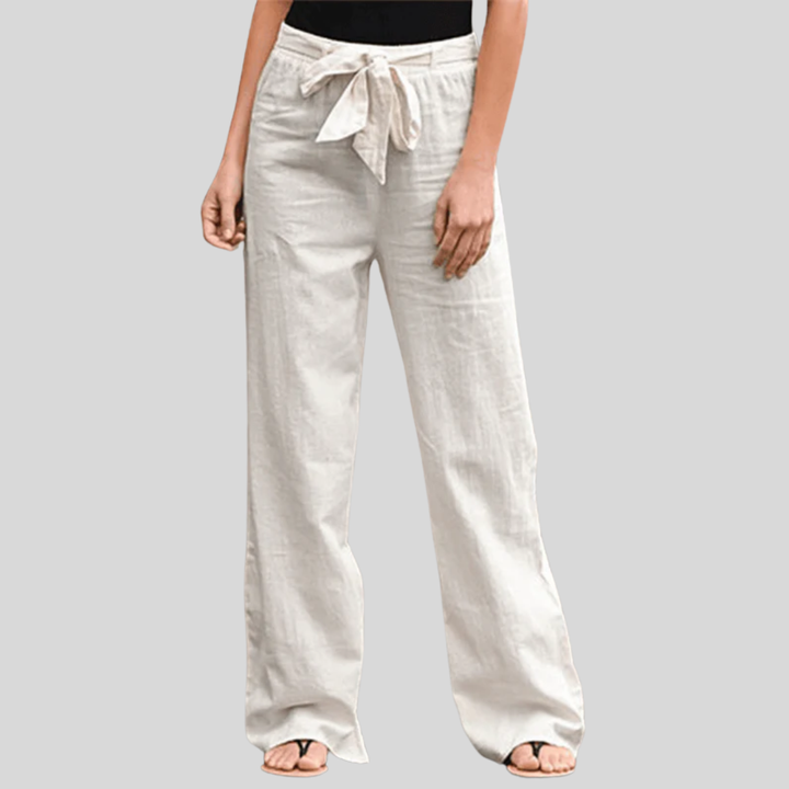 Woman wearing relaxed drawcord-waist trousers with a smart top, out for the day.