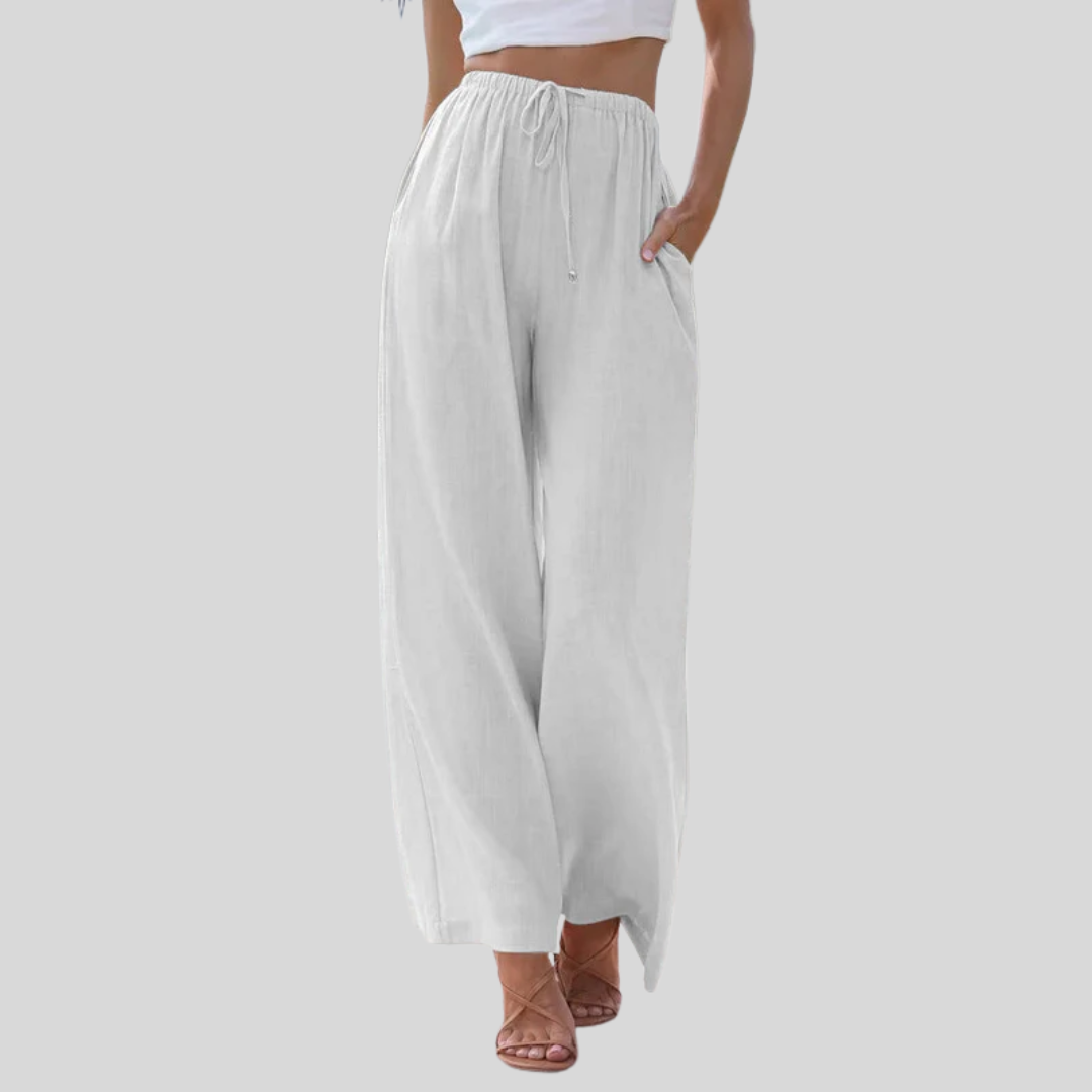 A woman in loose wide-leg summer trousers styled with a light top for an easy warm-weather look.
