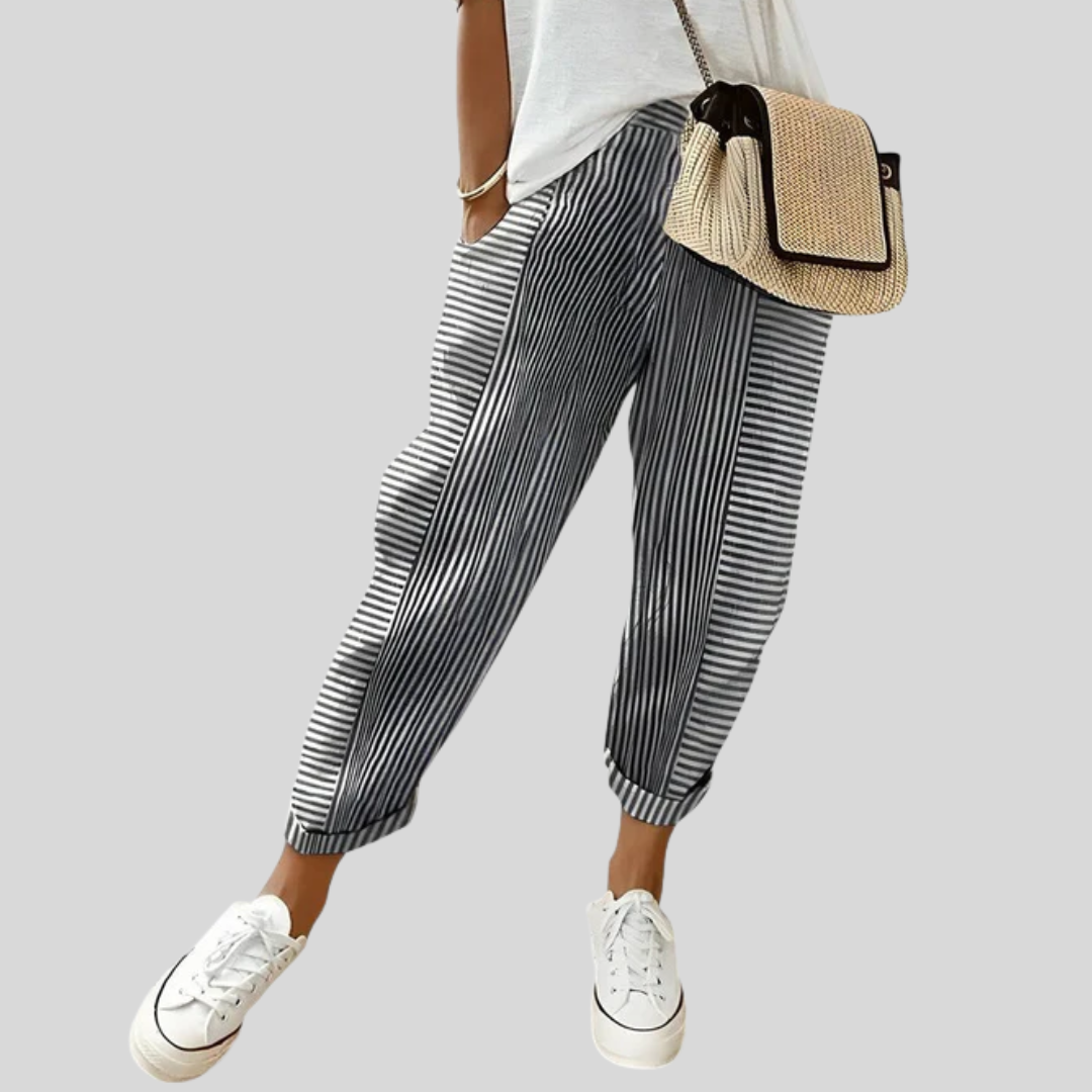A woman wearing airy comfy summer trousers with an elastic waist and side pockets.