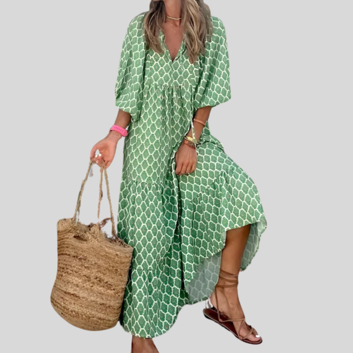 A woman wearing the Concepta spring print dress in green and pink tones, styled for a day out.