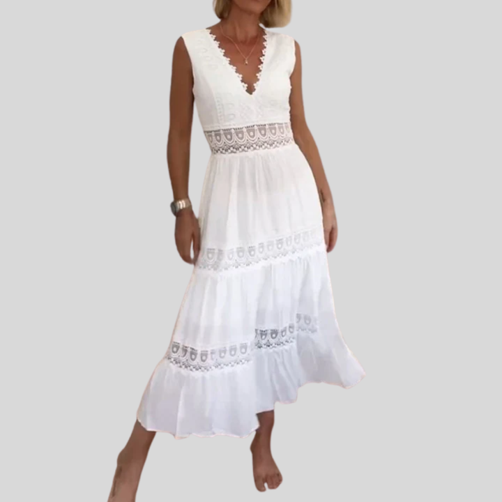 Woman wearing the Marian™ camisole maxi dress with delicate detailing and a flowing skirt at a summer gathering.