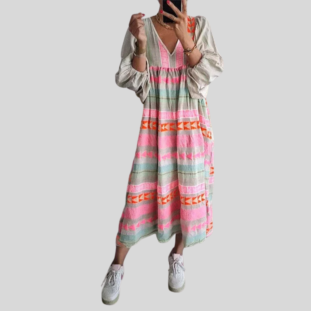 Woman wearing the Noreen™ colourful geometric print boho dress with puffed sleeves, out enjoying a casual day.