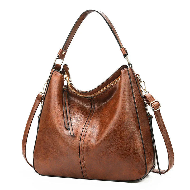 A woman holding a timeless classic handbag with a rich finish by her side