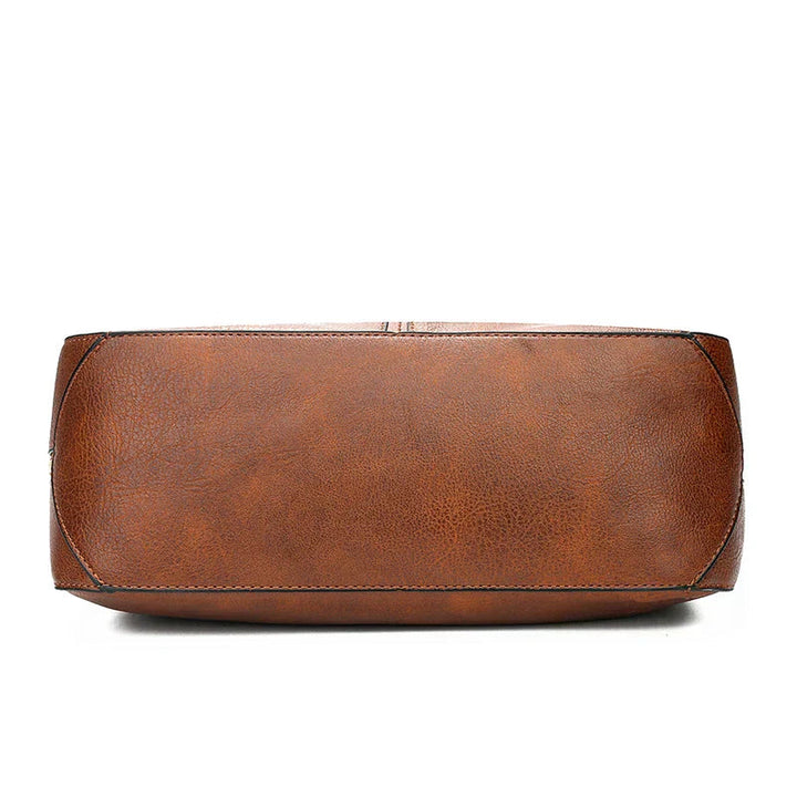 A woman holding a timeless classic handbag with a rich finish by her side