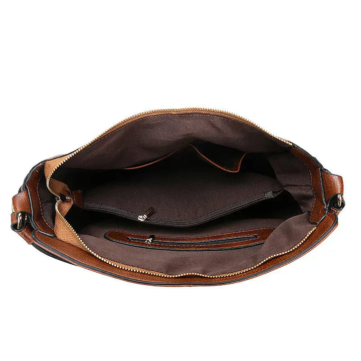 A woman holding a timeless classic handbag with a rich finish by her side