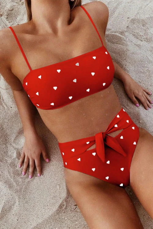 Pink high-waist bikini with a heart print pattern and an adjustable bow on the bottoms
