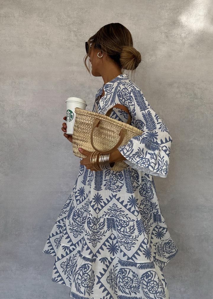 Woman wearing the Vivienne button-front boho tunic dress, relaxed on a casual day out.