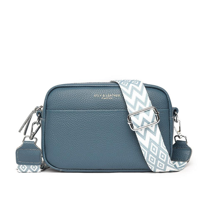 A woman wearing a timeless cross-body bag across her body while out and about
