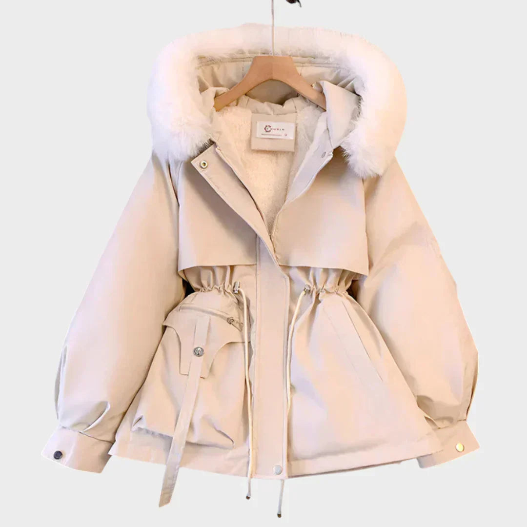An elegant structured winter coat in camel, styled over a layered winter outfit