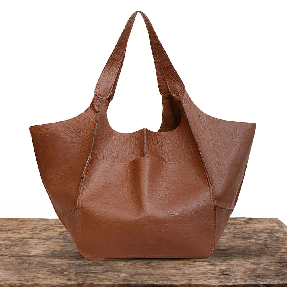 A woman carrying a vintage-style bag with a rich finish on a day out