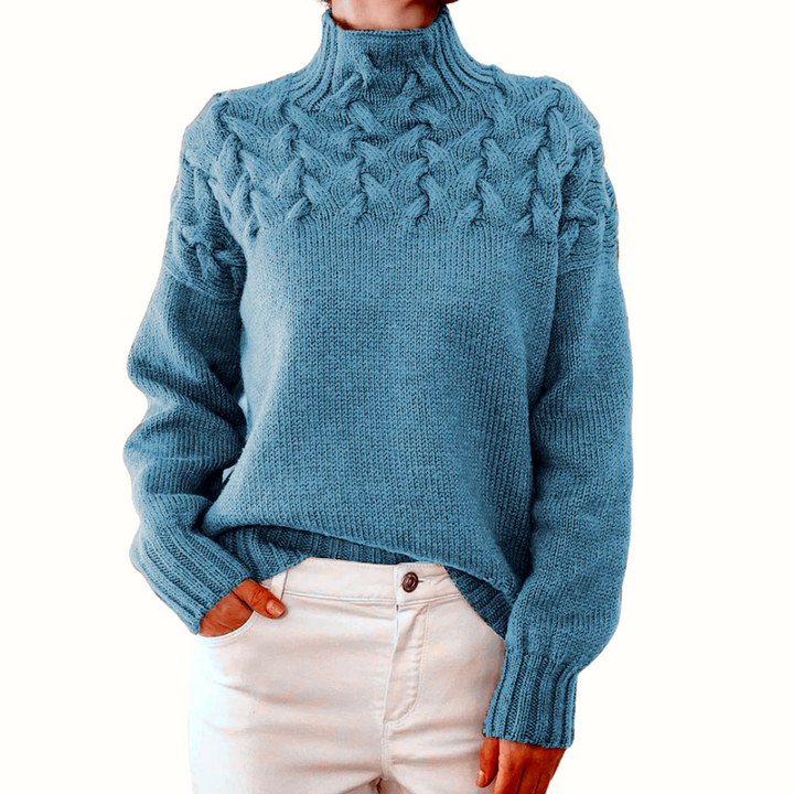 A woman wearing a warm roll-neck jumper, cosy and elegant on a cold winter day.