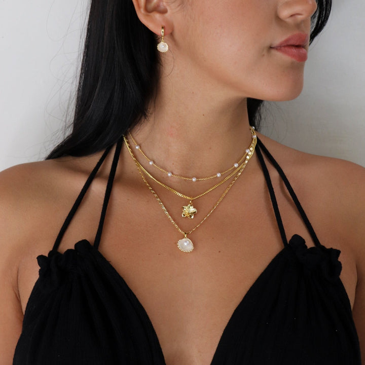 Gold initial letter pendant necklace on fine polished chain