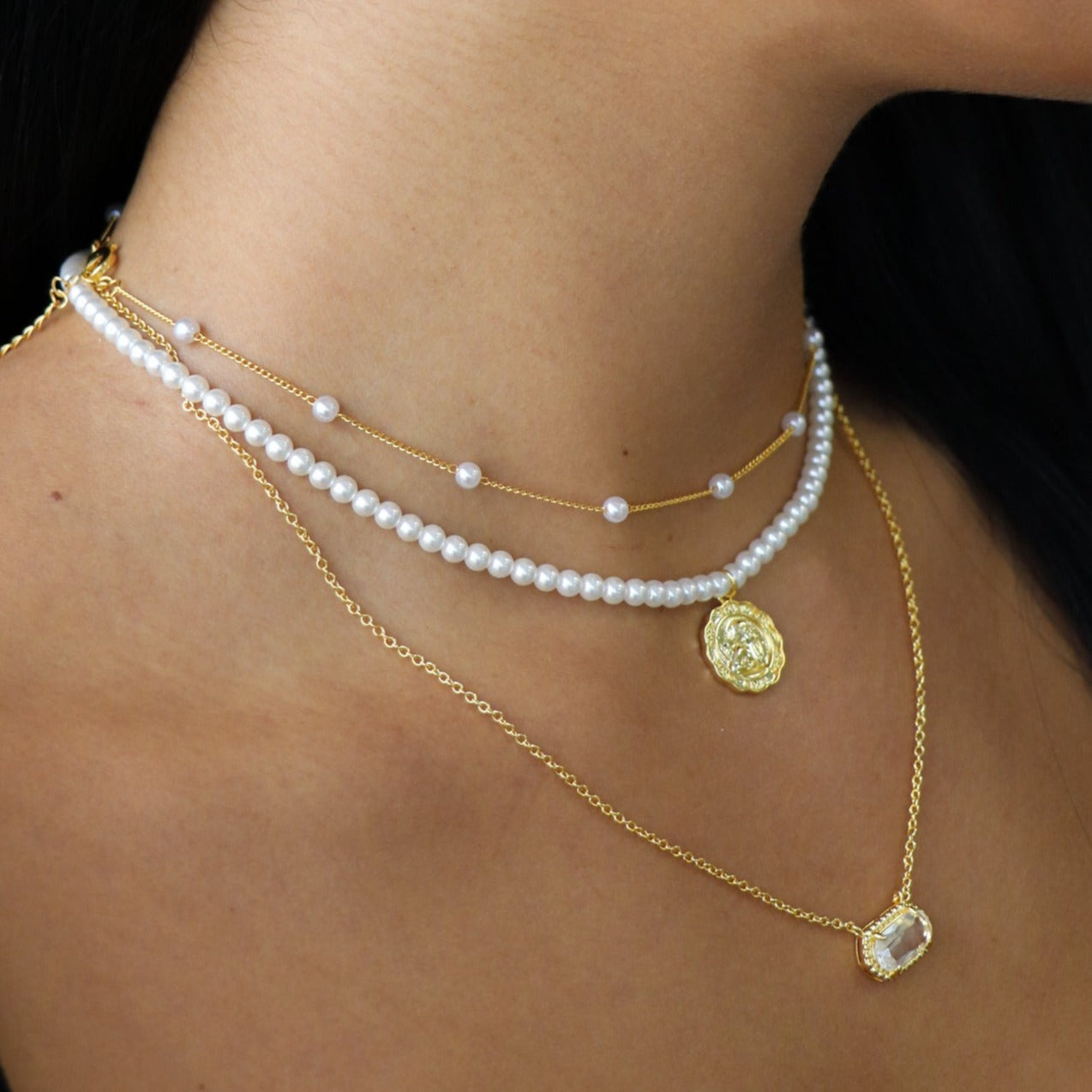Gold initial letter pendant necklace on fine polished chain