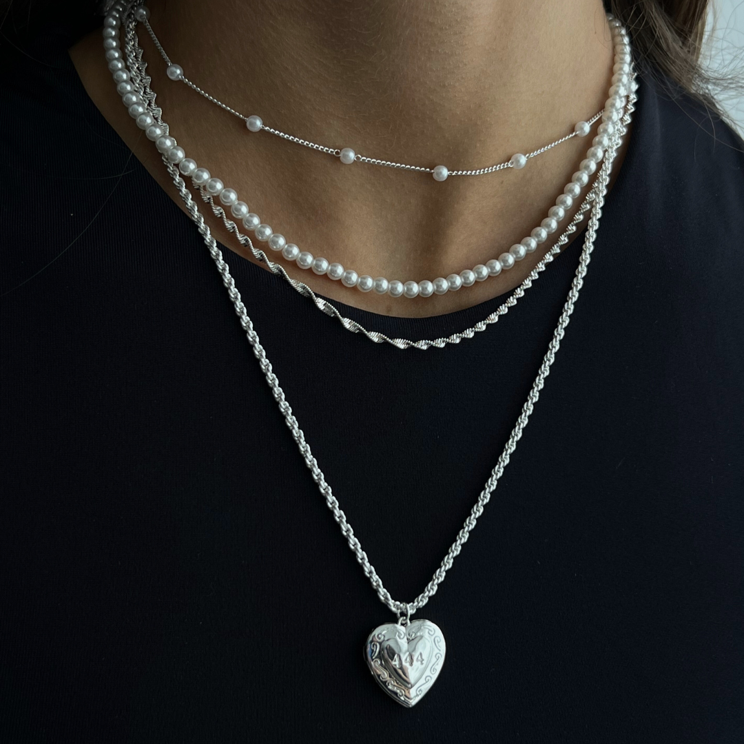 Gold initial letter pendant necklace on fine polished chain