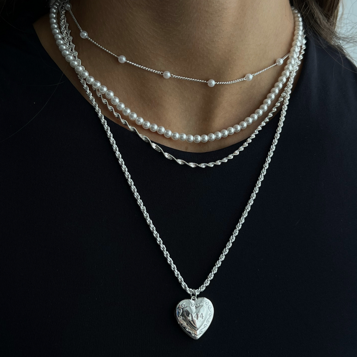 Gold initial letter pendant necklace on fine polished chain