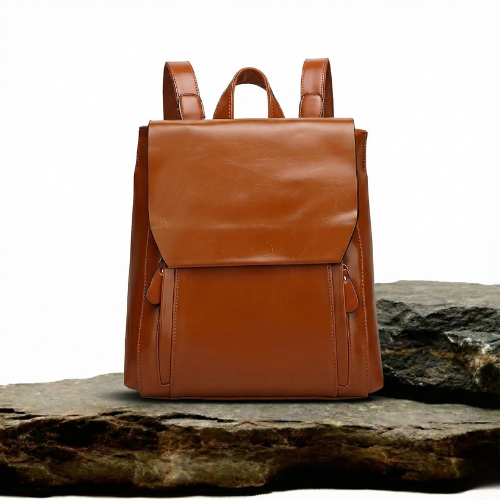 A woman wearing a padded vintage-style backpack over both shoulders while walking through the city.