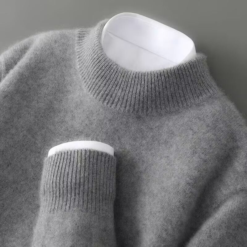 A woman wearing a soft luxe crew neck jumper with a matte finish, styled with smart trousers.
