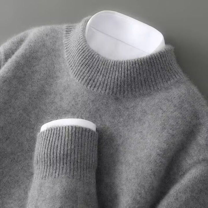A woman wearing a soft luxe crew neck jumper with a matte finish, styled with smart trousers.