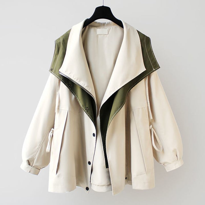 A woman wearing a lightweight weatherproof jacket with an adjustable hem on a blustery day.
