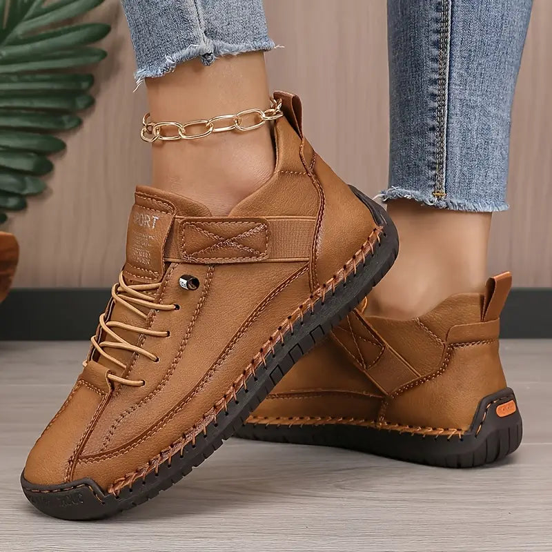A pair of comfortable slip-on shoes in beige with elastic side panels and a wide toe box